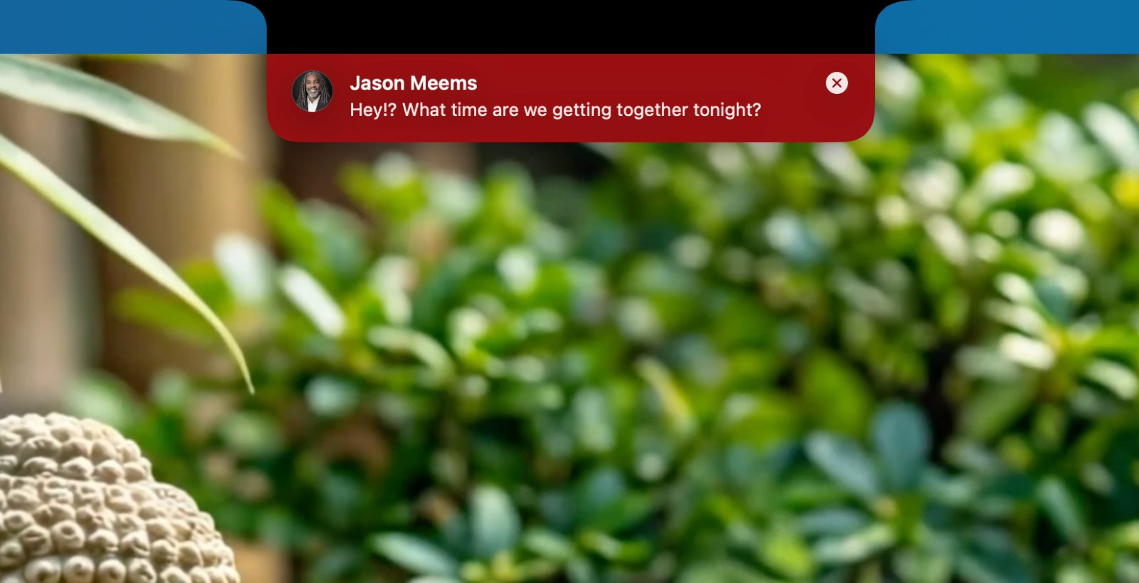 A VIP text message pinned to the top of the screen in the notch